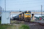 UP 8488 leads a manifest west under First Street. 